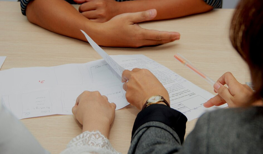 people reviewing papers at desk